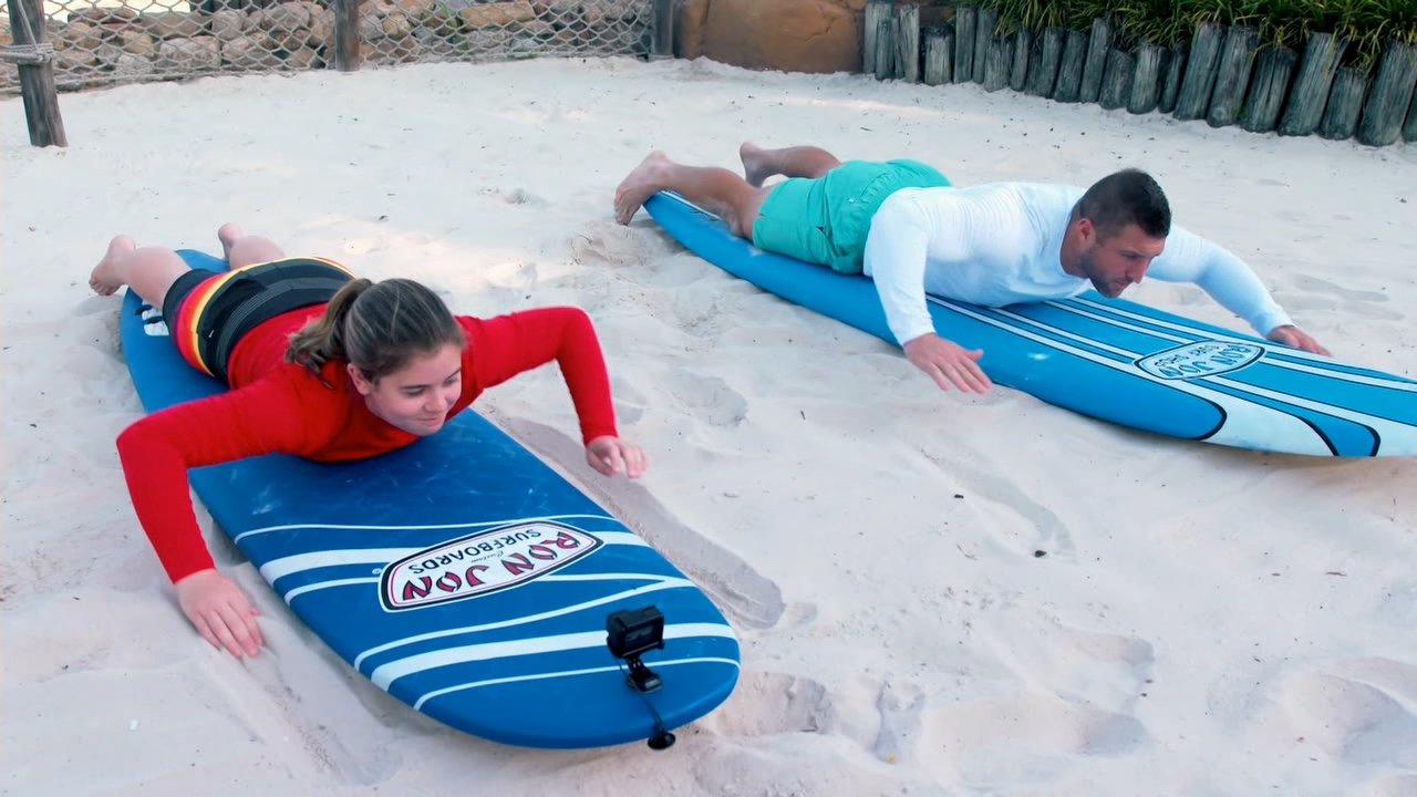 Tebow gets surfing lesson from Special Olympian Layla Crehan