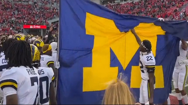 Michigan celebrates win over Ohio State by planting flag at midfield