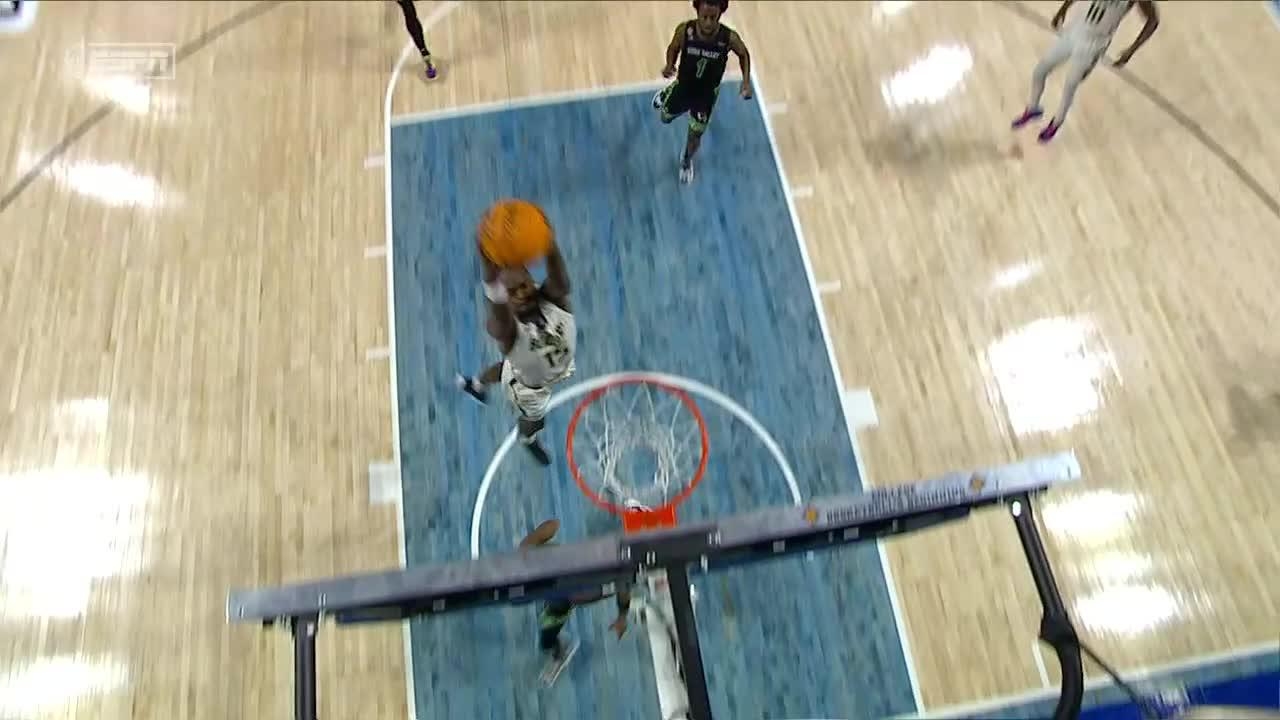 Ty Brewer swings from the rim after a mean two-handed slam dunk
