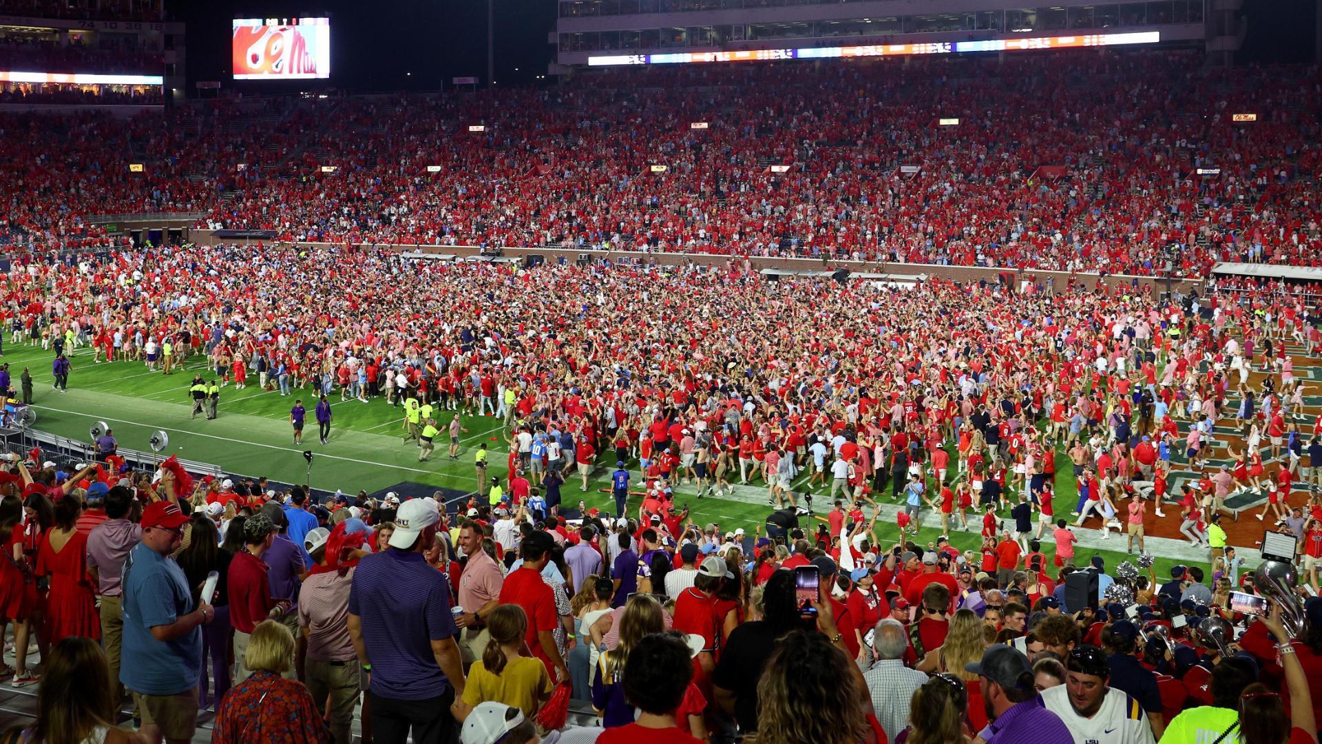 Ole Miss fans rush the field after hanging on to defeat LSU
