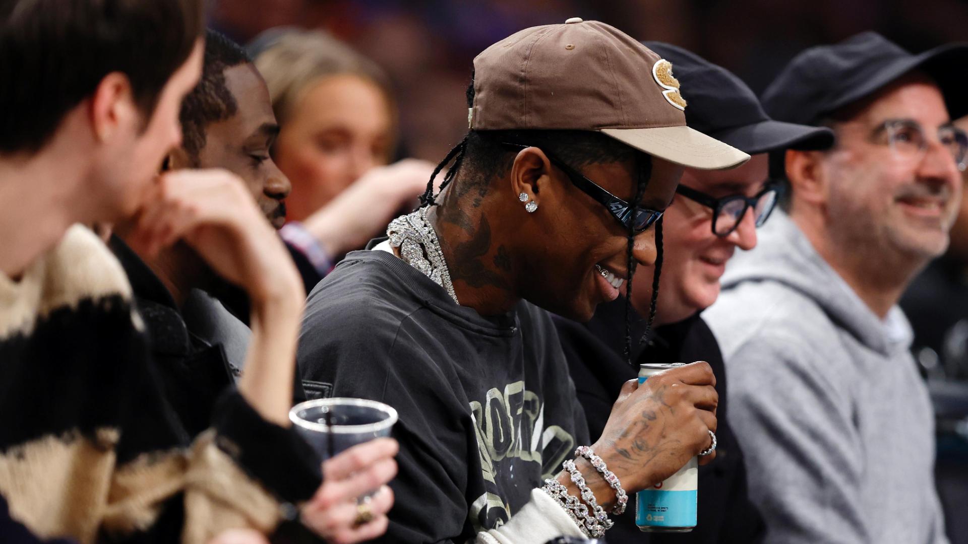 Celebrity spillage: Travis Scott loses drink during Knicks-Nets game