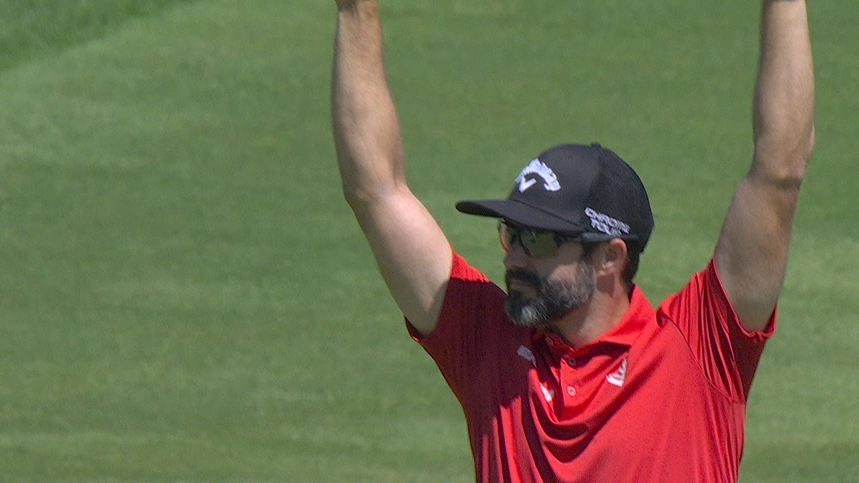 Adam Hadwin rolls in an eagle over the water on 13