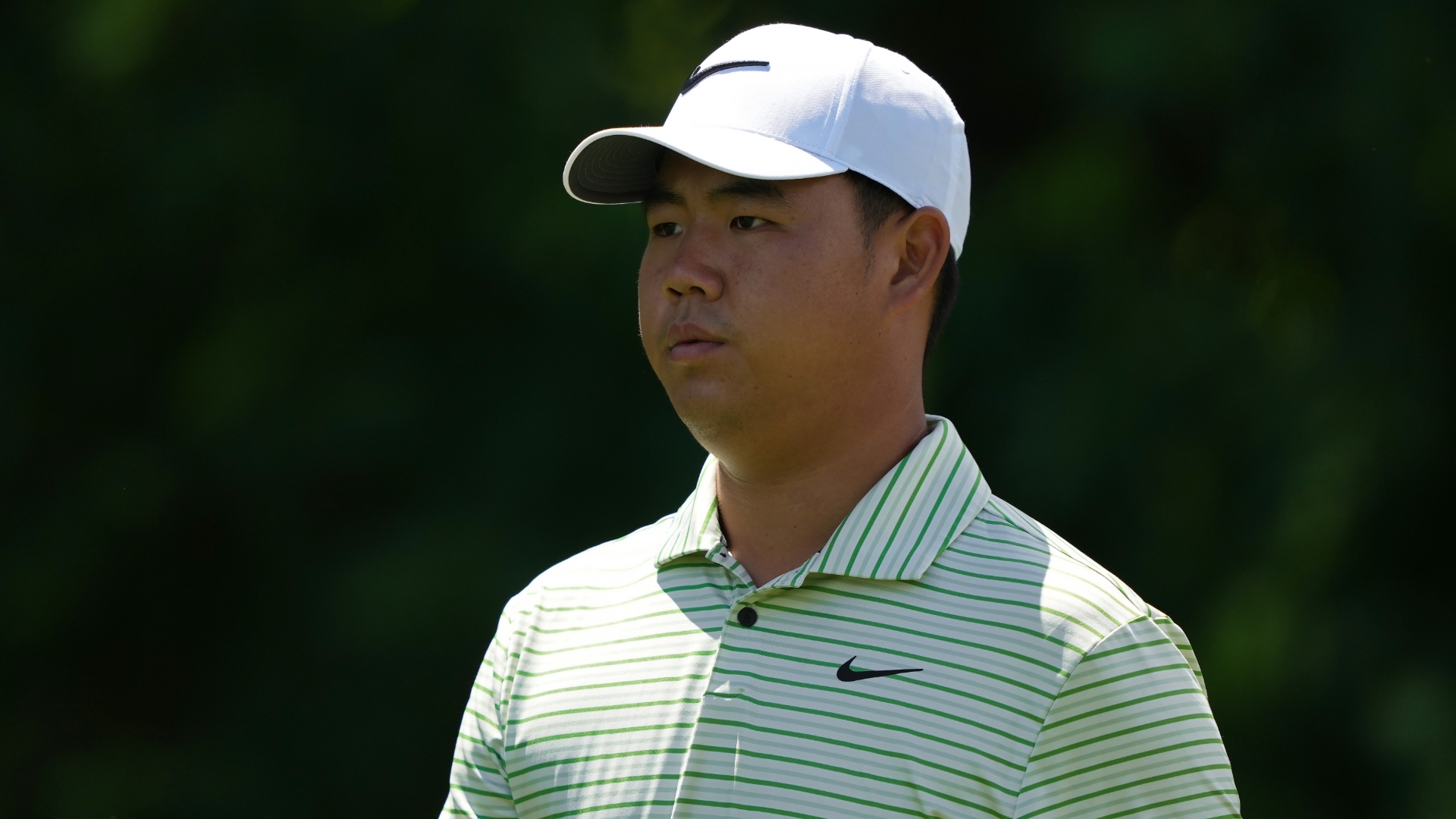 Tom Kim sees his chip from off the green fall for birdie
