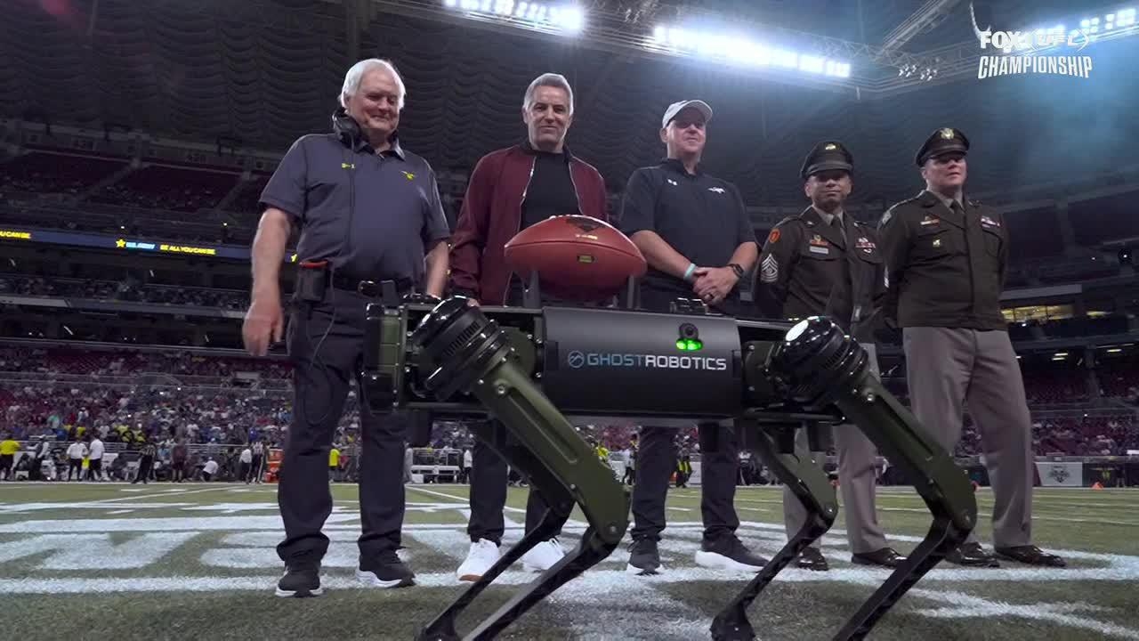 Robotic Dog presents game ball to Kurt Warner in UFL championship