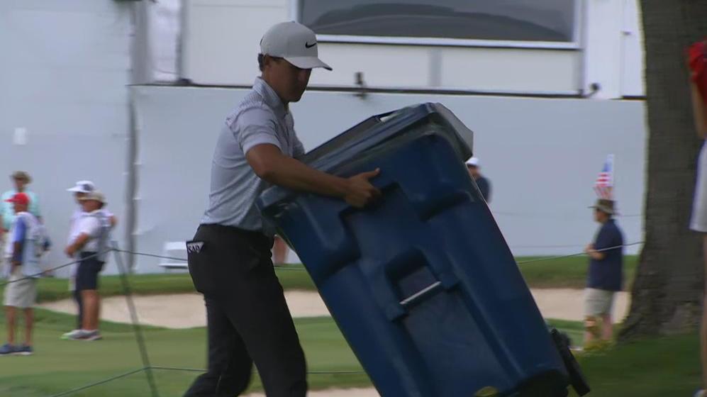 Cameron Champ clears away trash, recycling to get to his ball