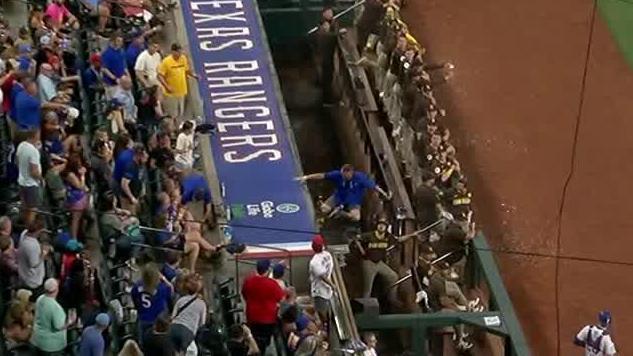 Fan gets on dugout to catch a foul ball and falls into netting