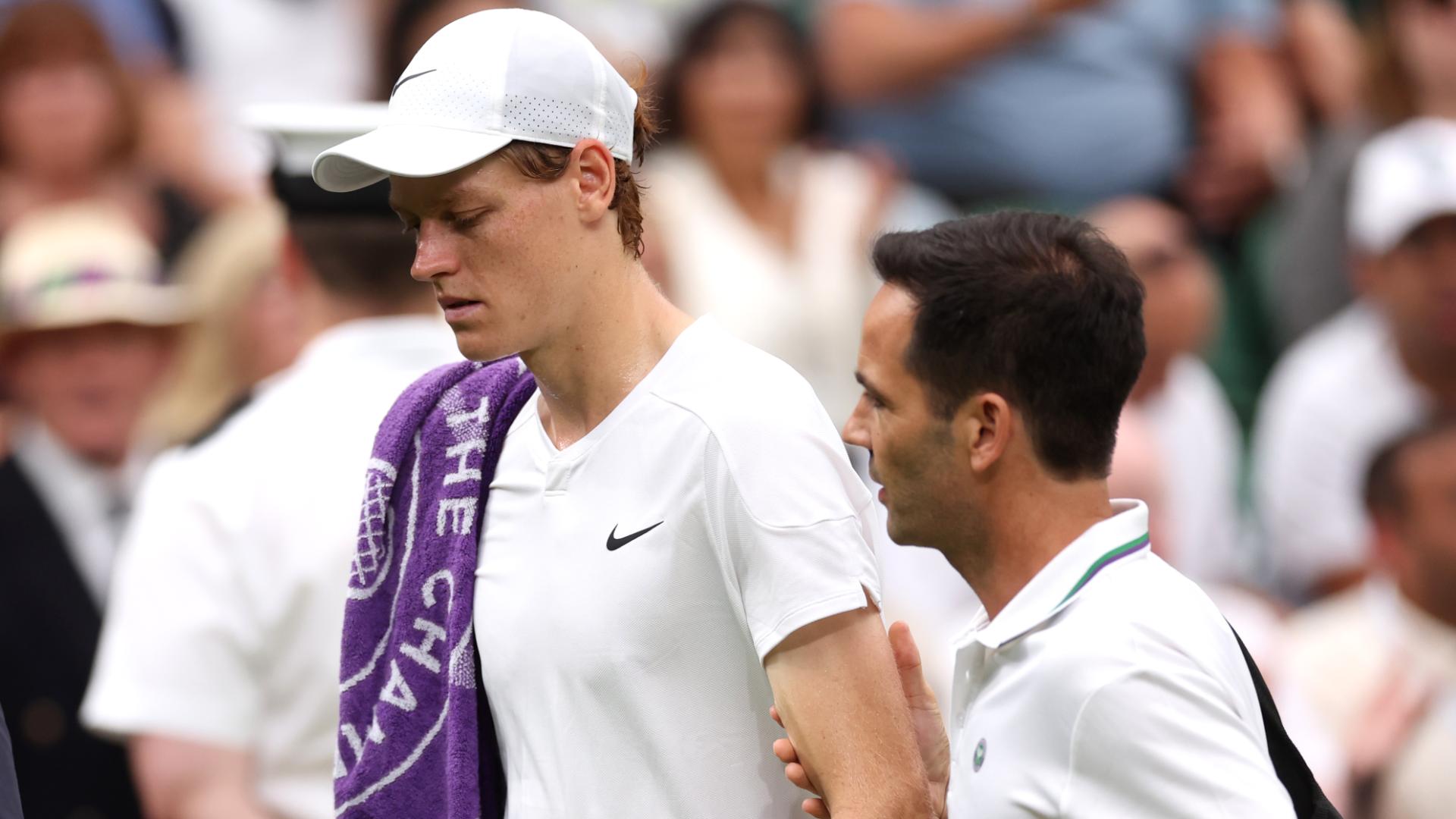 Jannik Sinner leaves the court after receiving treatment