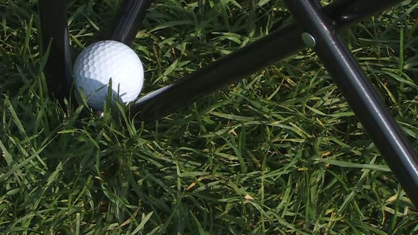 Davis Riley wedges his shot into the legs of a lawn chair