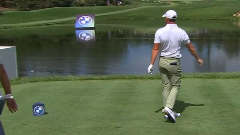 McIlroy bounces his 3-wood into the water after errant tee shot