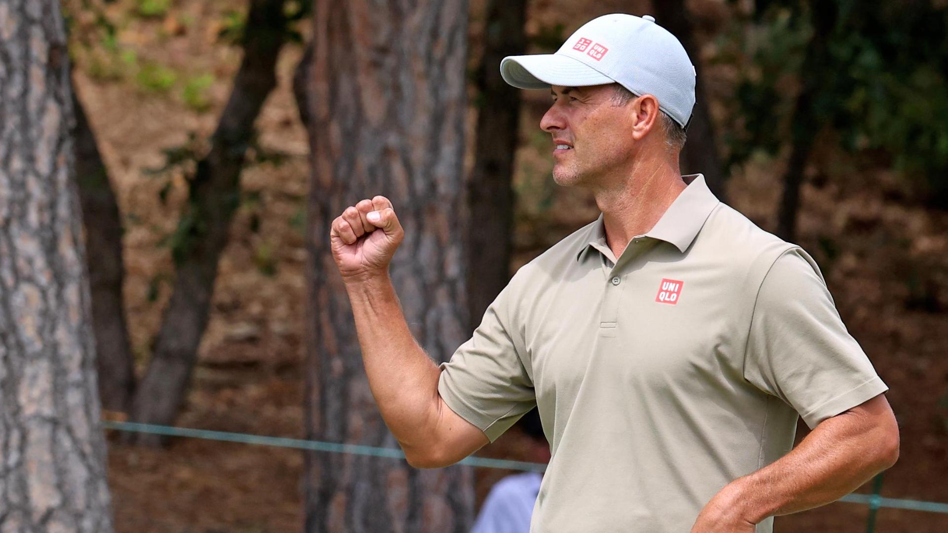 Adam Scott buries a 40-foot eagle putt for a share of the lead