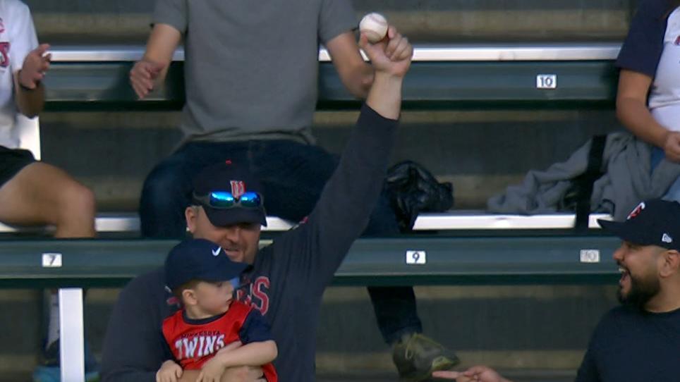 Twins fans catches HR ball while holding a child