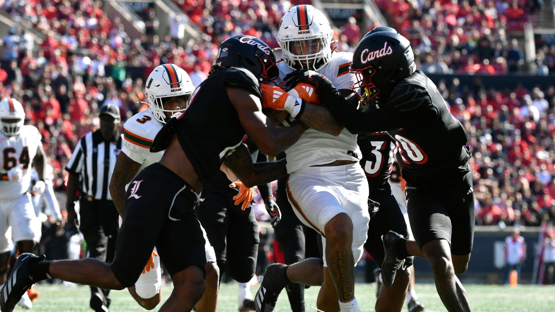 Damien Martinez drags Louisville defenders into end zone for a Miami TD