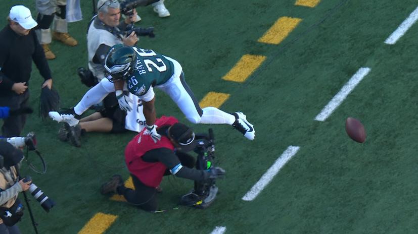 Saquon Barkley hurdles over a cameraman