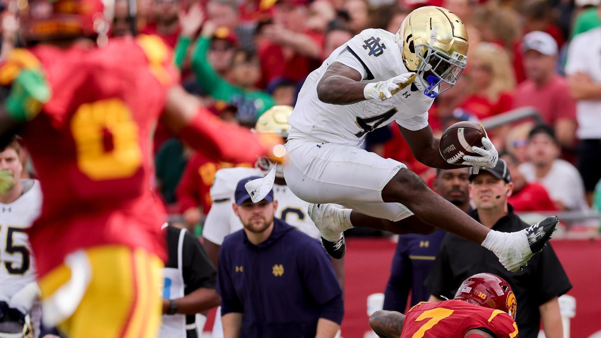 Notre Dame's Jeremiyah Love hurdles a USC defender