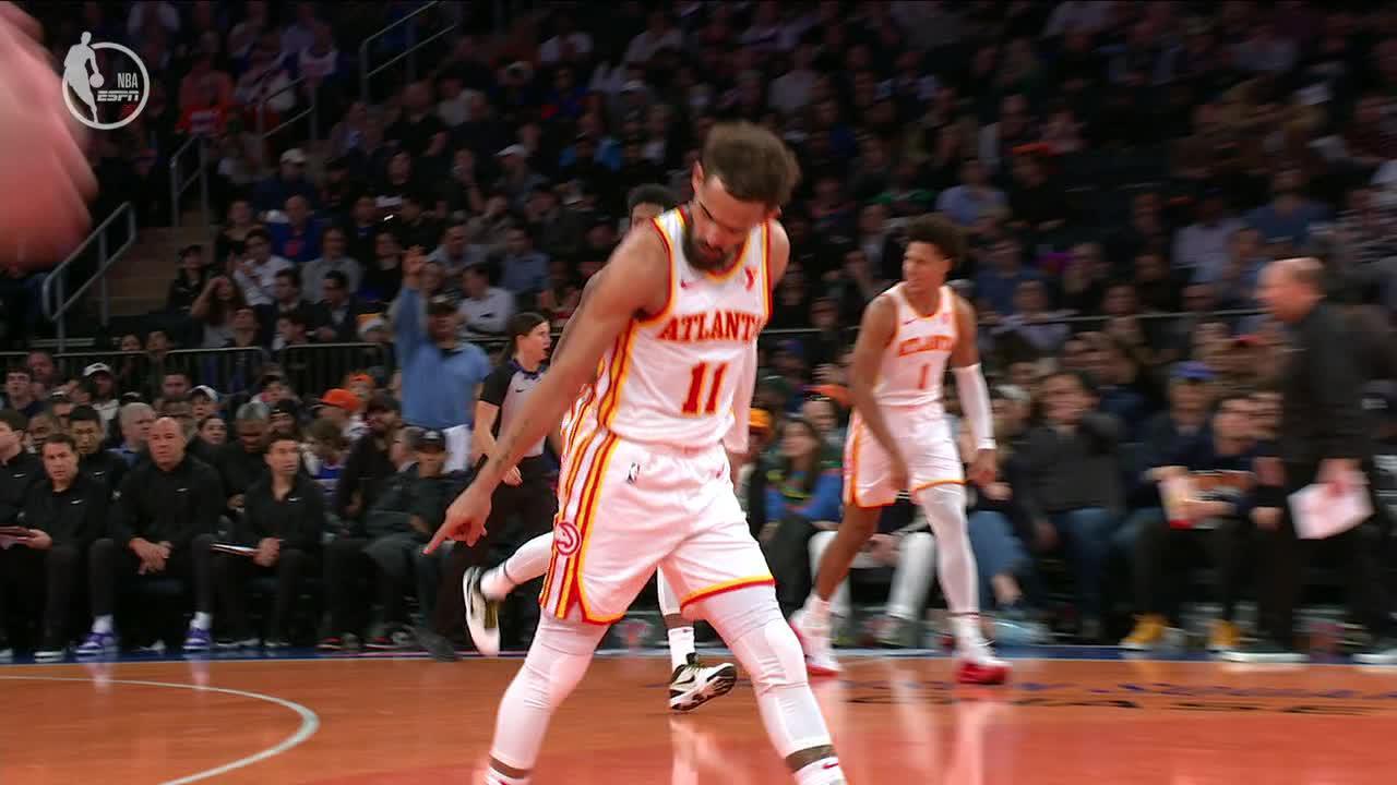 Trae Young points to the spot where he sank a 3