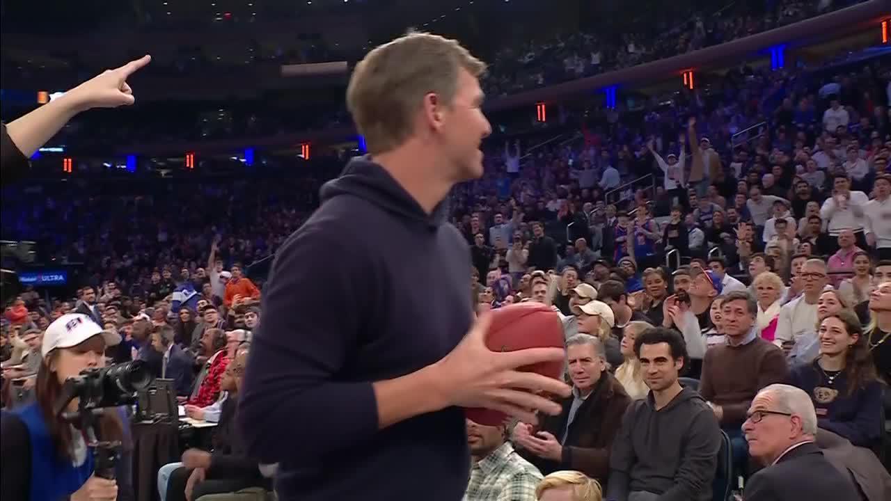 Eli Manning launches a signed football into the MSG crowd