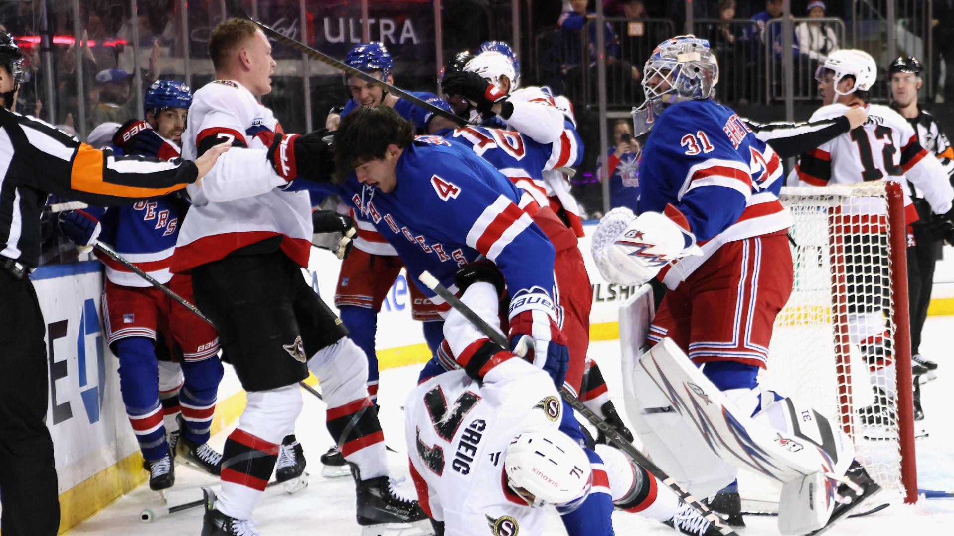 Igor Shesterkin charges at Brady Tkachuk during scrum