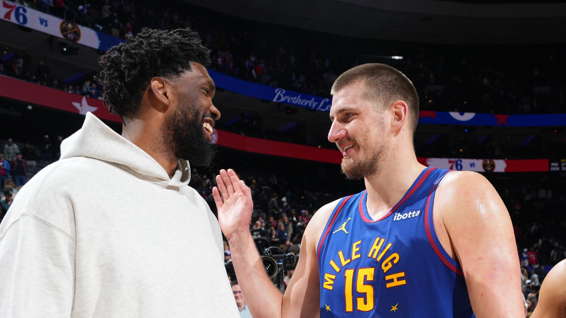 Nikola Jokic and Joel Embiid embrace after Nuggets' win