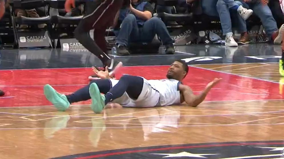 Marcus Smart does a kip-up after taking a charge