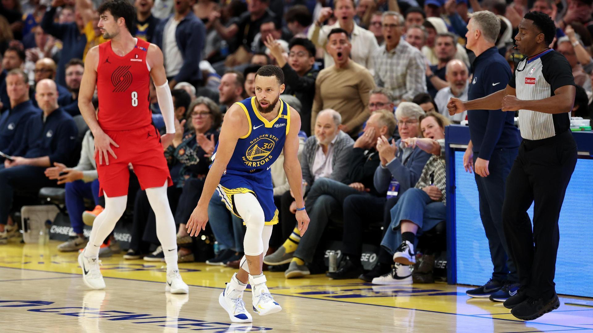 Stephen Curry nails the triple while falling down