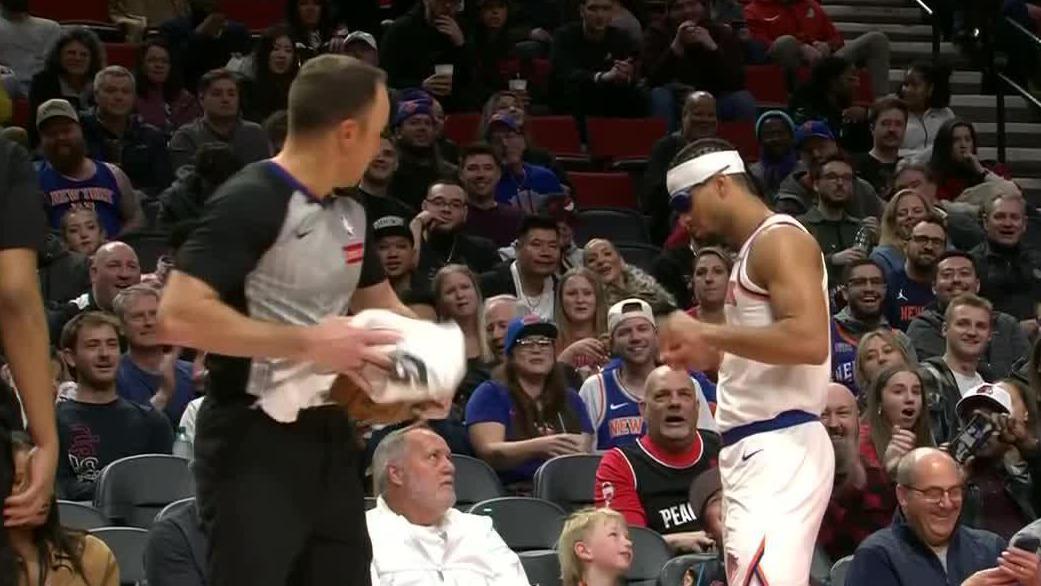 Josh Hart puts on fan's glasses after throwing a dime