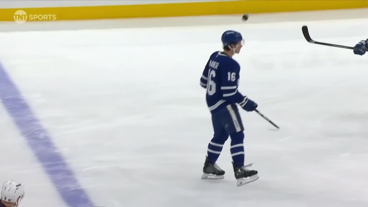 Mitch Marner uses a header to deflect the puck