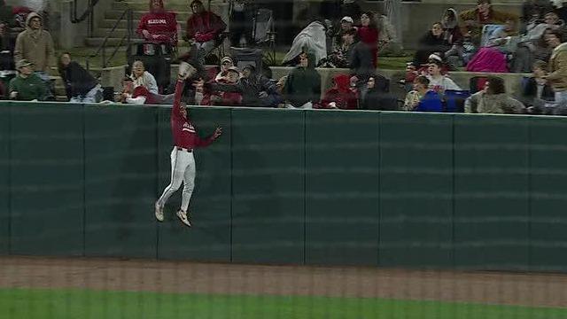 Bama's Bryce Fowler climbs the wall for a HR robbery