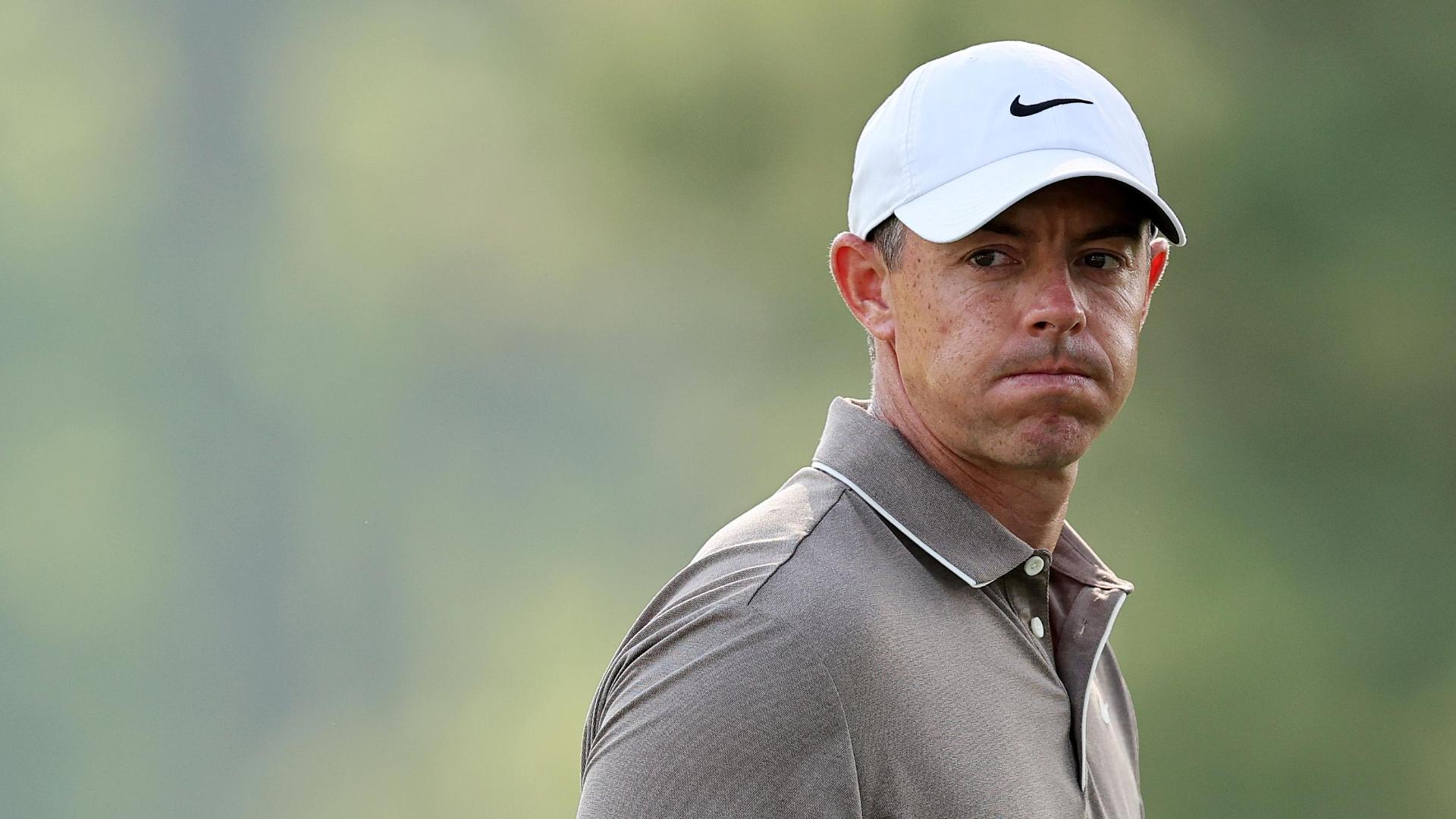 Rory chips through green into the water