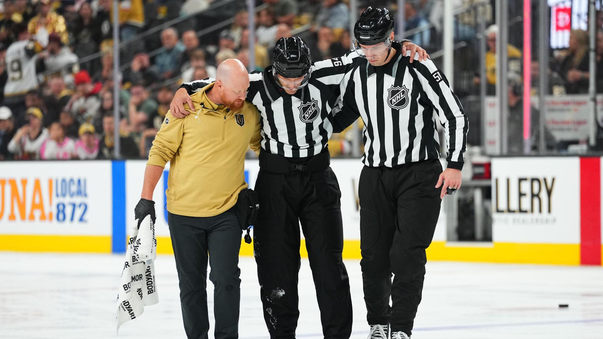 Referee needs to be escorted off the ice due to injury