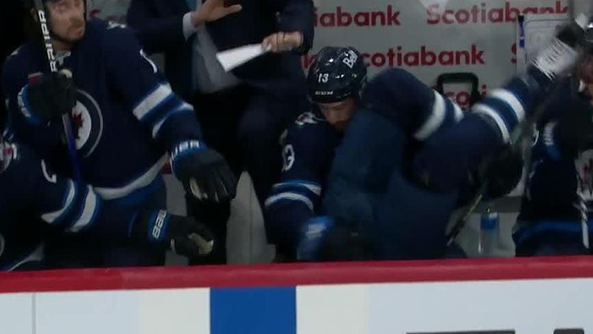 Alex Petrovic's punishing hit flips Adam Lowry into the bench