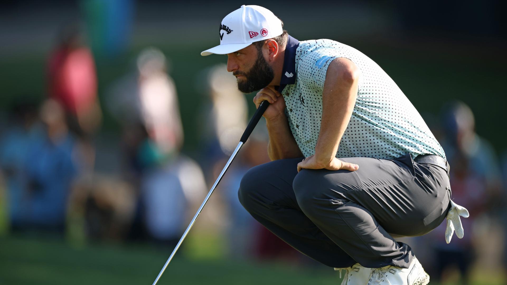 Jon Rahm sinks a long birdie putt on the 11th hole