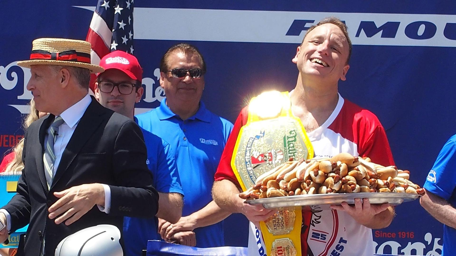 Joey Chestnut reclaims hot dog eating crown by downing 70.5 hot dogs