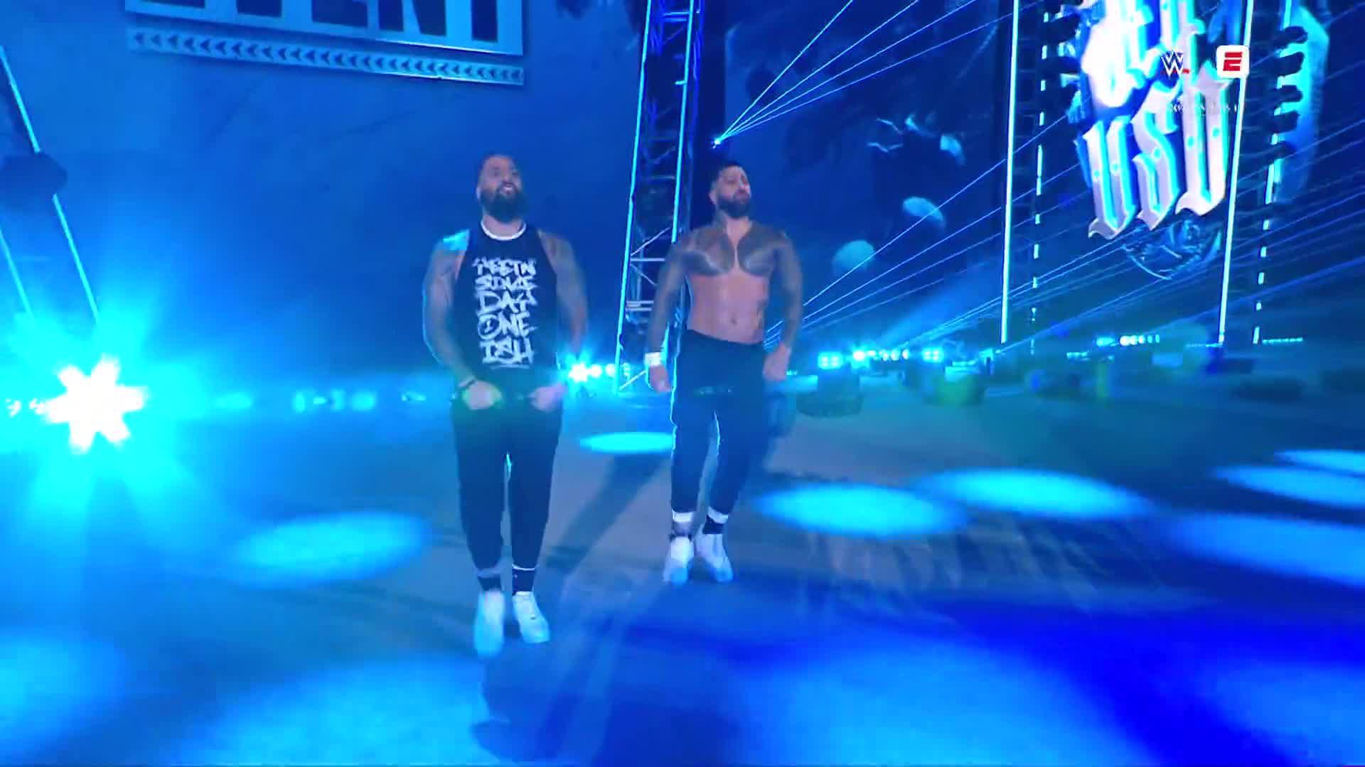 The Usos come out to save Roman Reigns